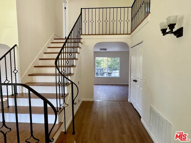 a view of entryway and hall with wooden floor