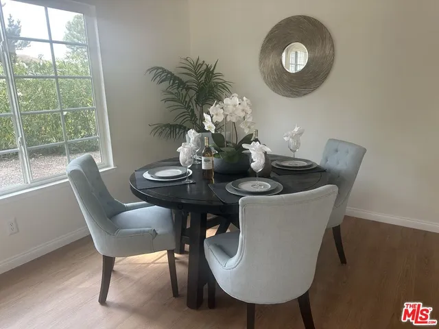 a view of staircase with wooden floor and white walls