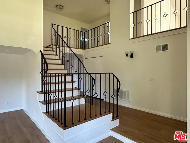 a large kitchen with a large window and stainless steel appliances