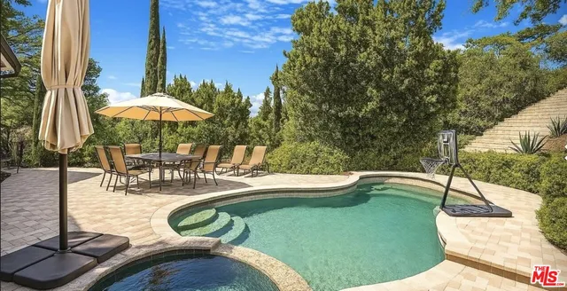 a view of a swimming pool with a patio