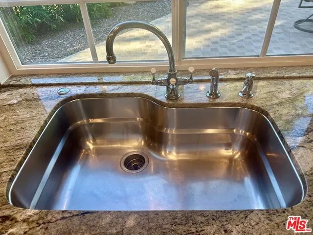 a view of a backyard with furniture and a garden