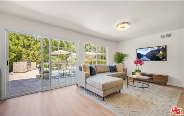 a view of backyard with outdoor seating and plants