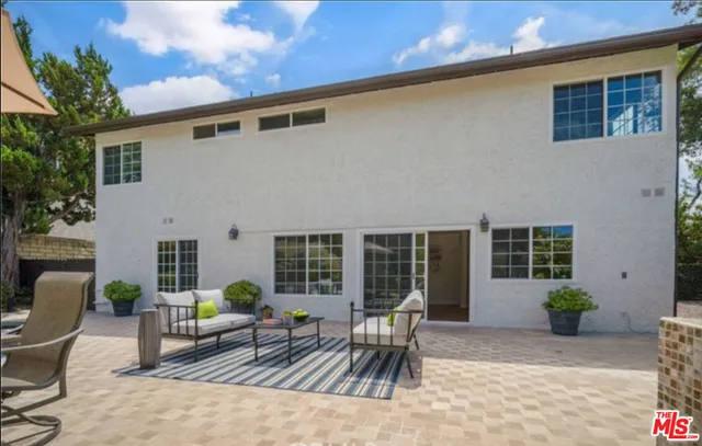 a bathroom with a granite countertop shower sink vanity mirror and toilet