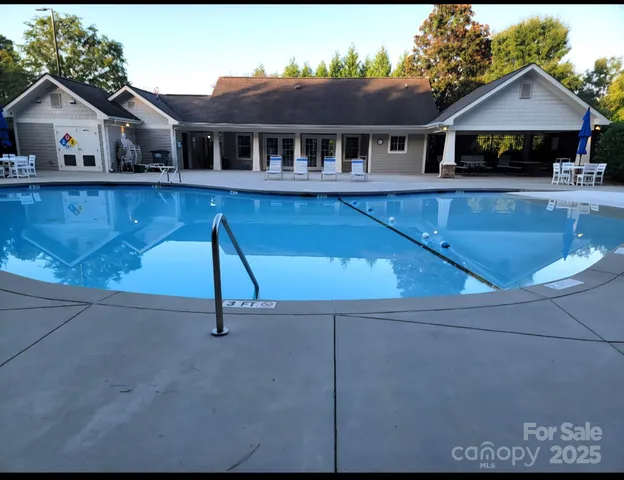 a front view of a house with a yard and potted plants