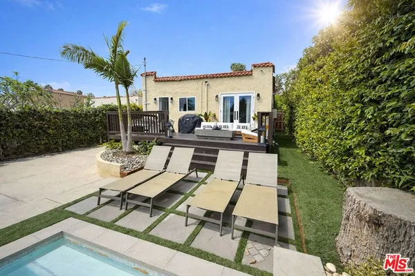 a view of a patio with table and chairs and potted plants