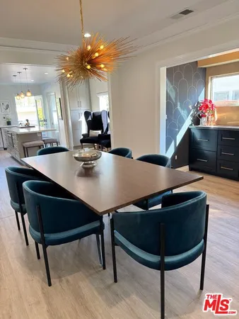 a room with dining table and chairs