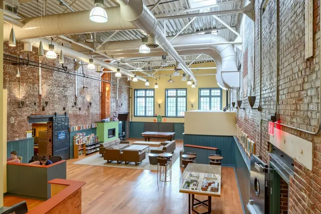 a living room with fireplace furniture and a wooden floor