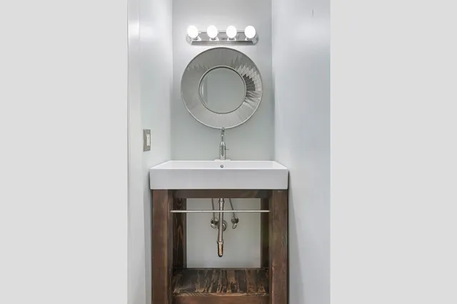 a bathroom with a sink and a mirror