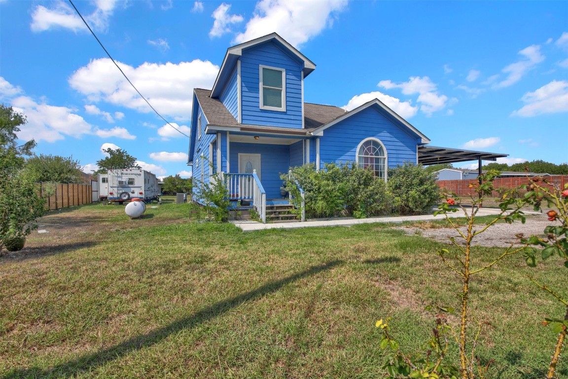 a view of a house with yard and a garden