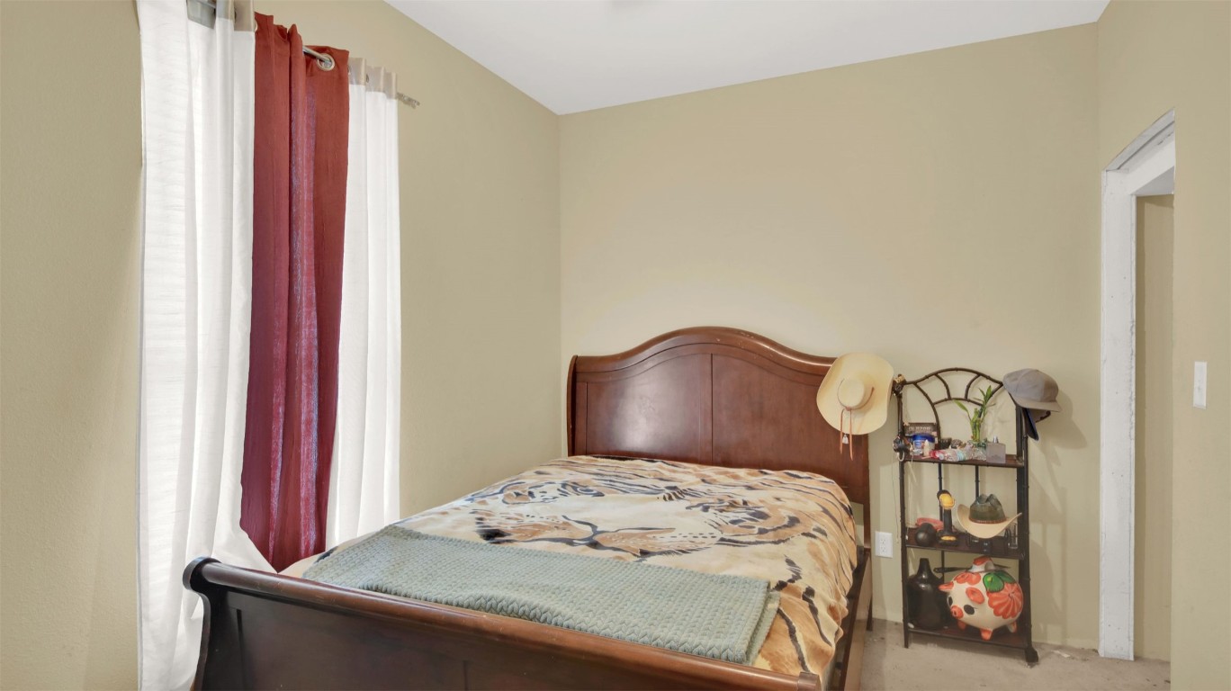 120 Rio Vista Ranch Road Dale, TX 78616 - Photo 11 of 22 a bedroom with a bed and a chandelier