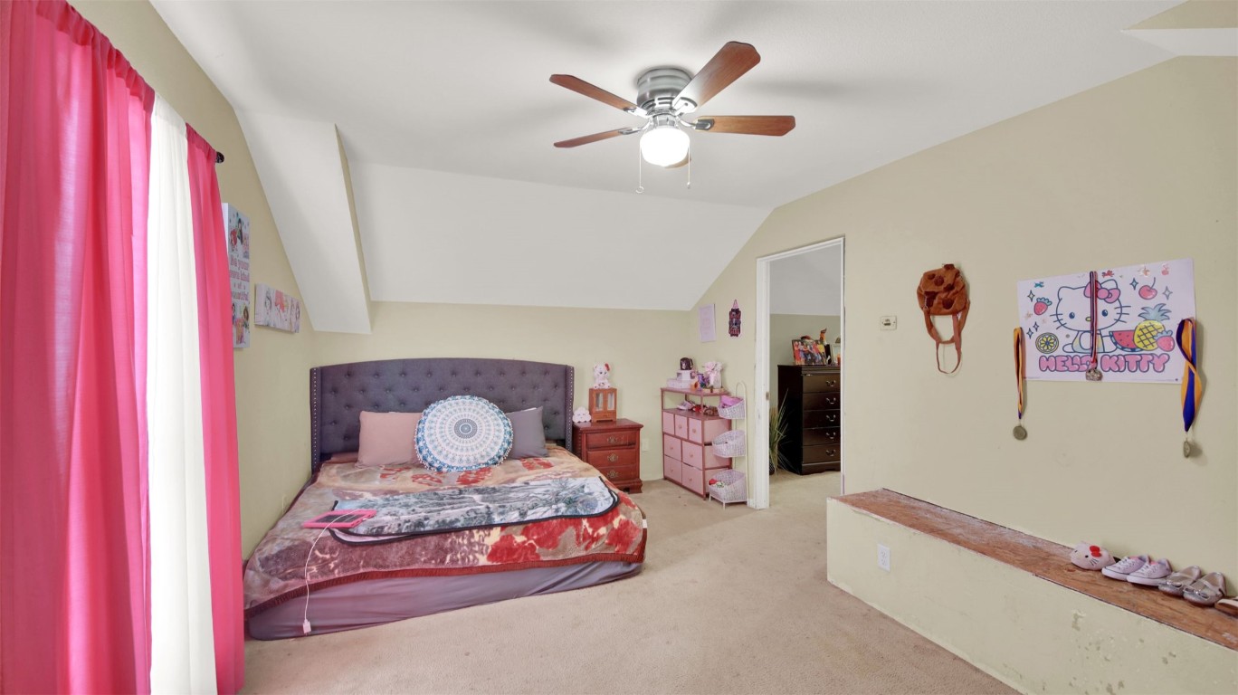 120 Rio Vista Ranch Road Dale, TX 78616 - Photo 12 of 22 a bedroom with a bed and a chandelier