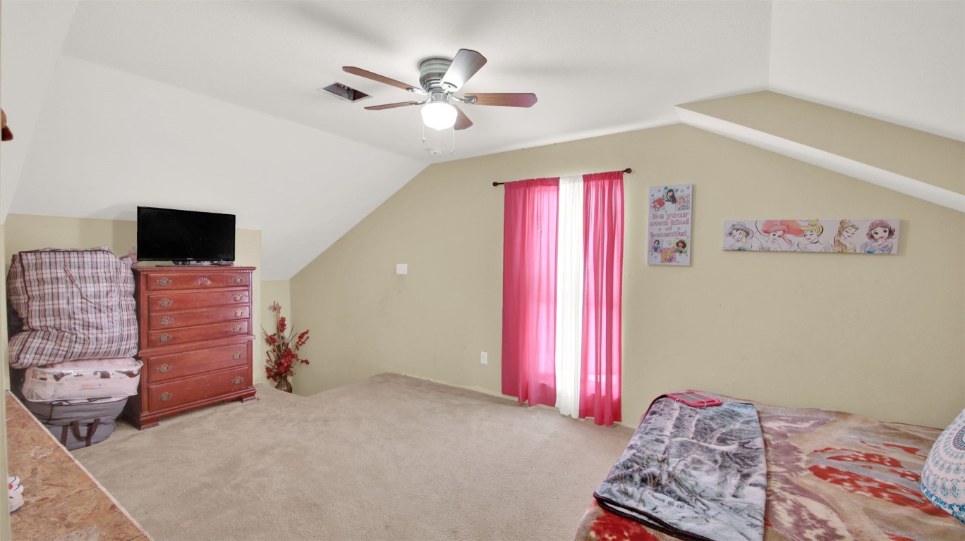 120 Rio Vista Ranch Road Dale, TX 78616 - Photo 13 of 22 a bedroom with a bed and a chandelier