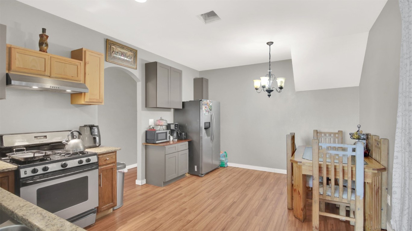 120 Rio Vista Ranch Road Dale, TX 78616 - Photo 6 of 22 a kitchen with stainless steel appliances granite countertop a stove and a refrigerator