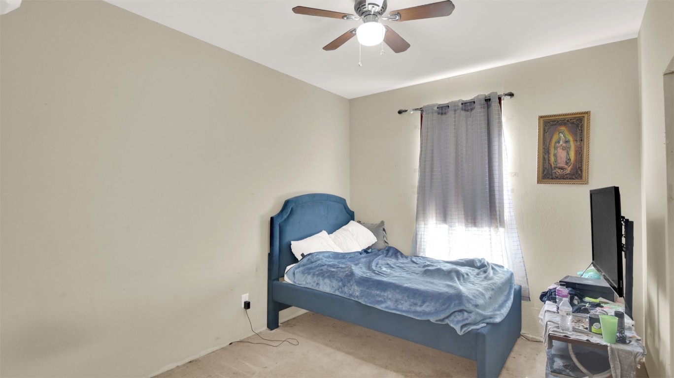 120 Rio Vista Ranch Road Dale, TX 78616 - Photo 9 of 22 a bedroom with a bed and a chandelier