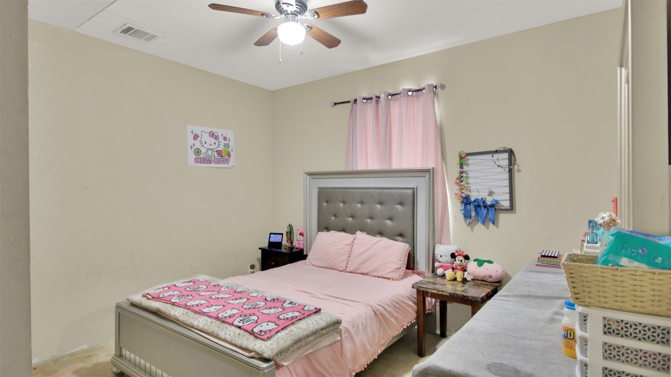 120 Rio Vista Ranch Road Dale, TX 78616 - Photo 10 of 22 a bedroom with a bed and a chandelier