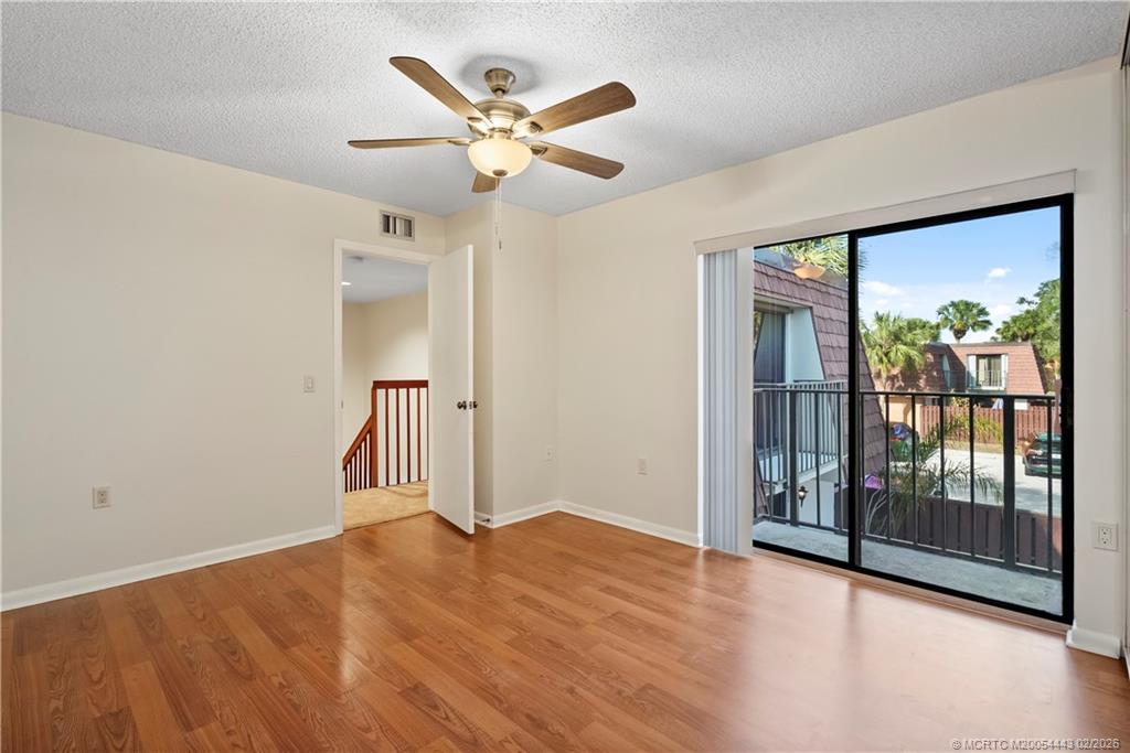 2930 Southwest Sunset Trace Circle Palm City, FL 34990 - Photo 18 of 31 wooden floor in an empty room with a window