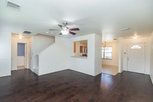 a view of an empty room with wooden floor