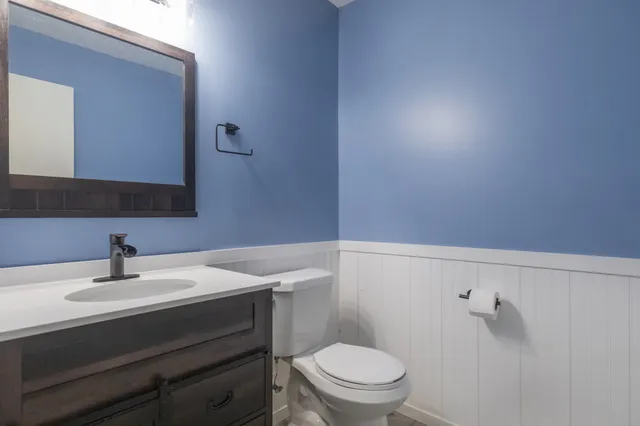 a bathroom with a sink toilet and mirror