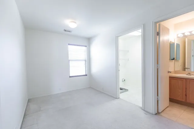an empty room with a bathroom and a sink