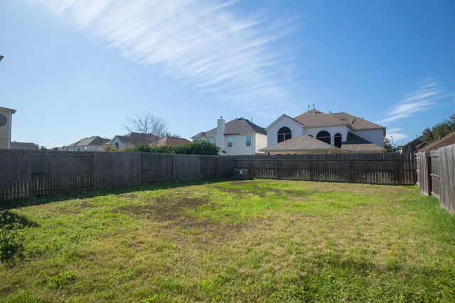 a view of garden with tall house