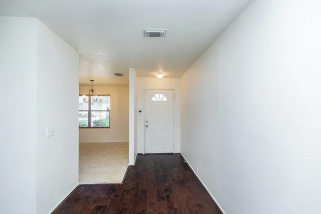 a view of hallway with wooden floor