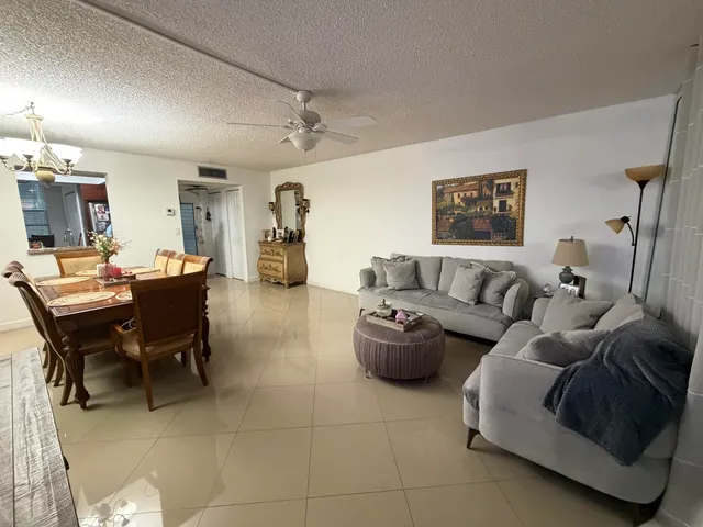 a living room with furniture and a dining table