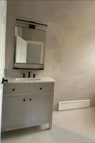 a bathroom with a sink a toilet and mirror