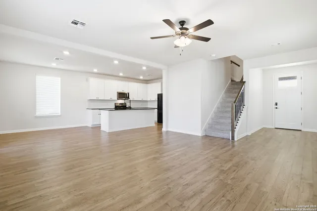 a view of a kitchen with a sink cabinets and wooden floor