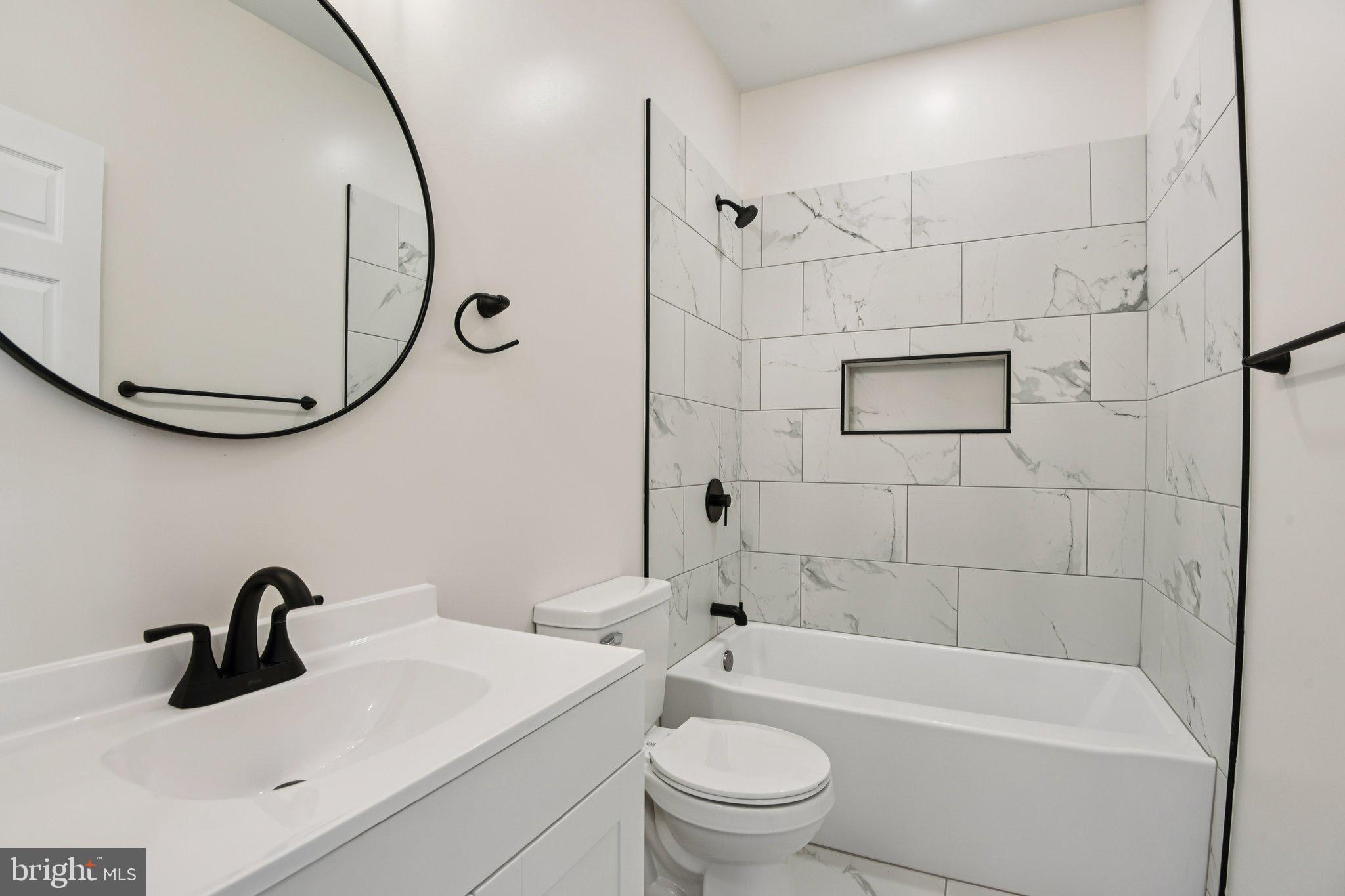 2223 Roslyn Avenue Baltimore, MD 21216 - Photo 12 of 32 a bathroom with a sink a toilet and a mirror