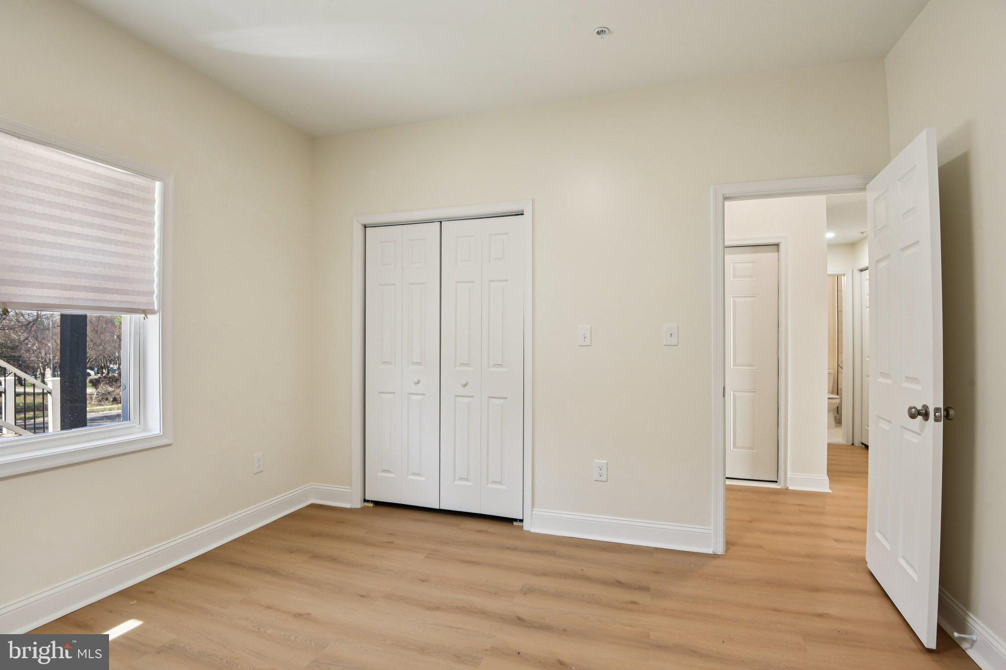 2223 Roslyn Avenue Baltimore, MD 21216 - Photo 15 of 32 a view of an empty room with wooden floor and a window