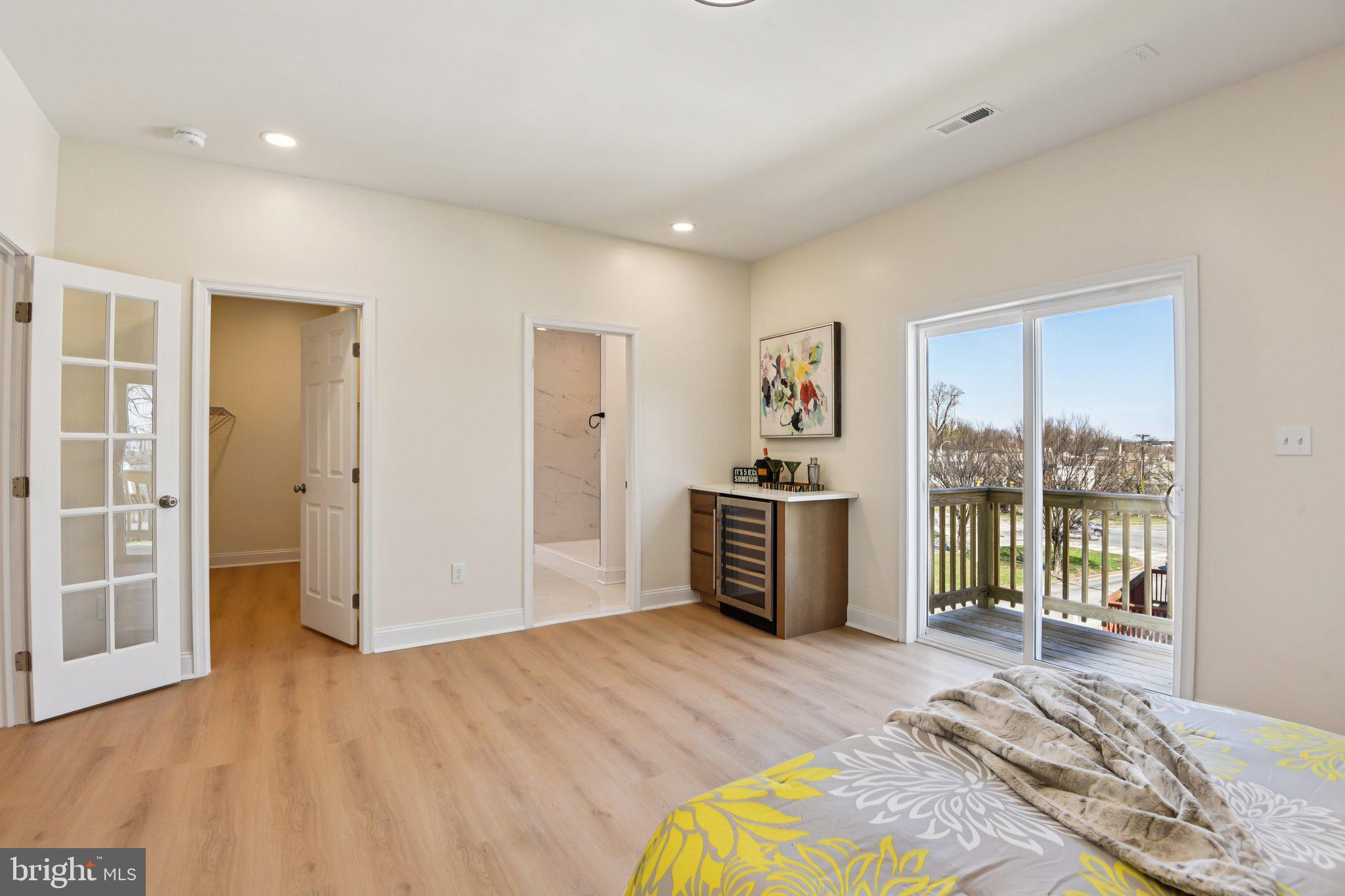 2223 Roslyn Avenue Baltimore, MD 21216 - Photo 23 of 32 a view of a bedroom with a bed and wooden floor