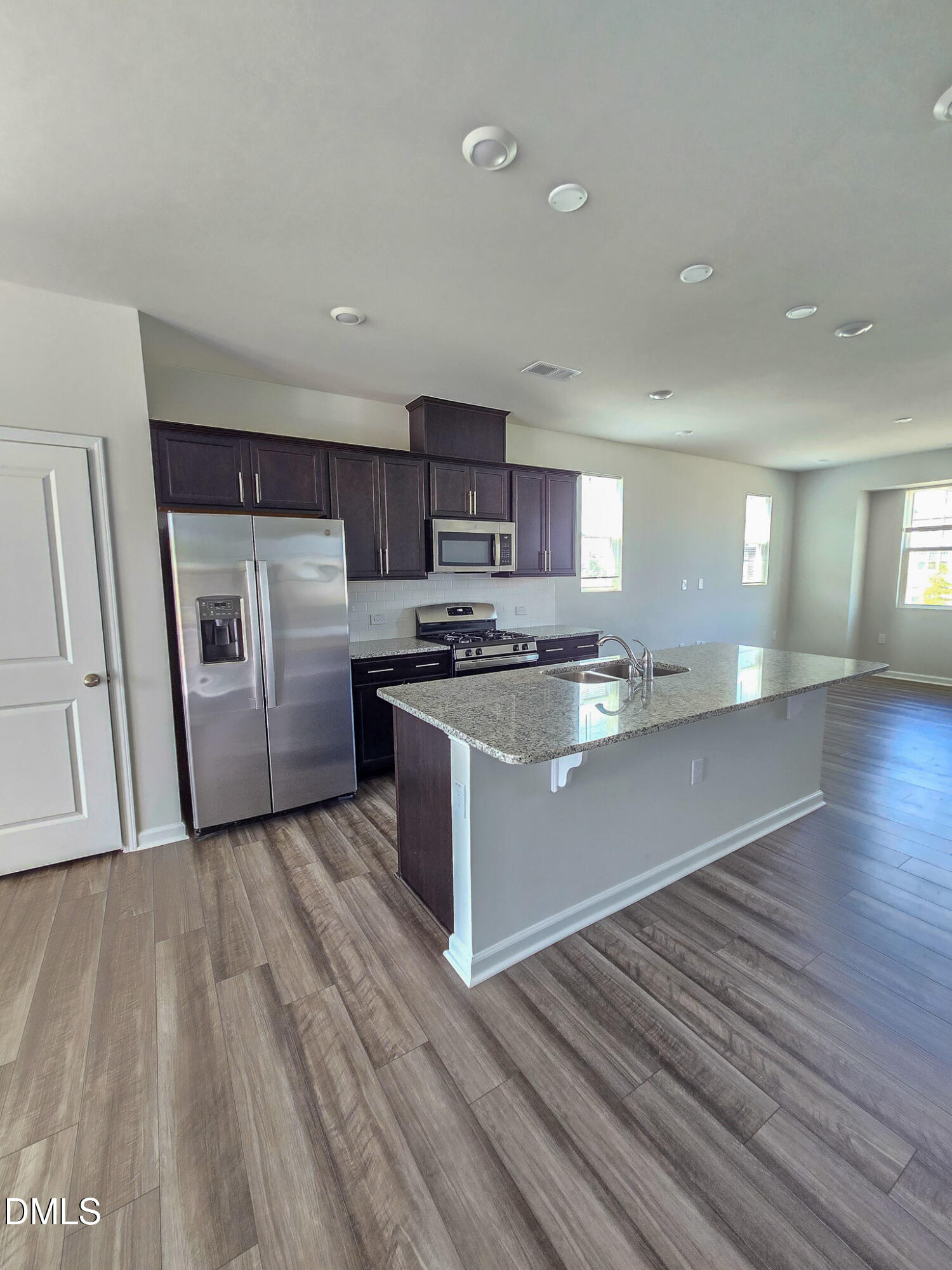 2431 Kasota Lane Raleigh, NC 27610 - Photo 13 of 46 a kitchen with stainless steel appliances granite countertop a stove a sink and a refrigerator