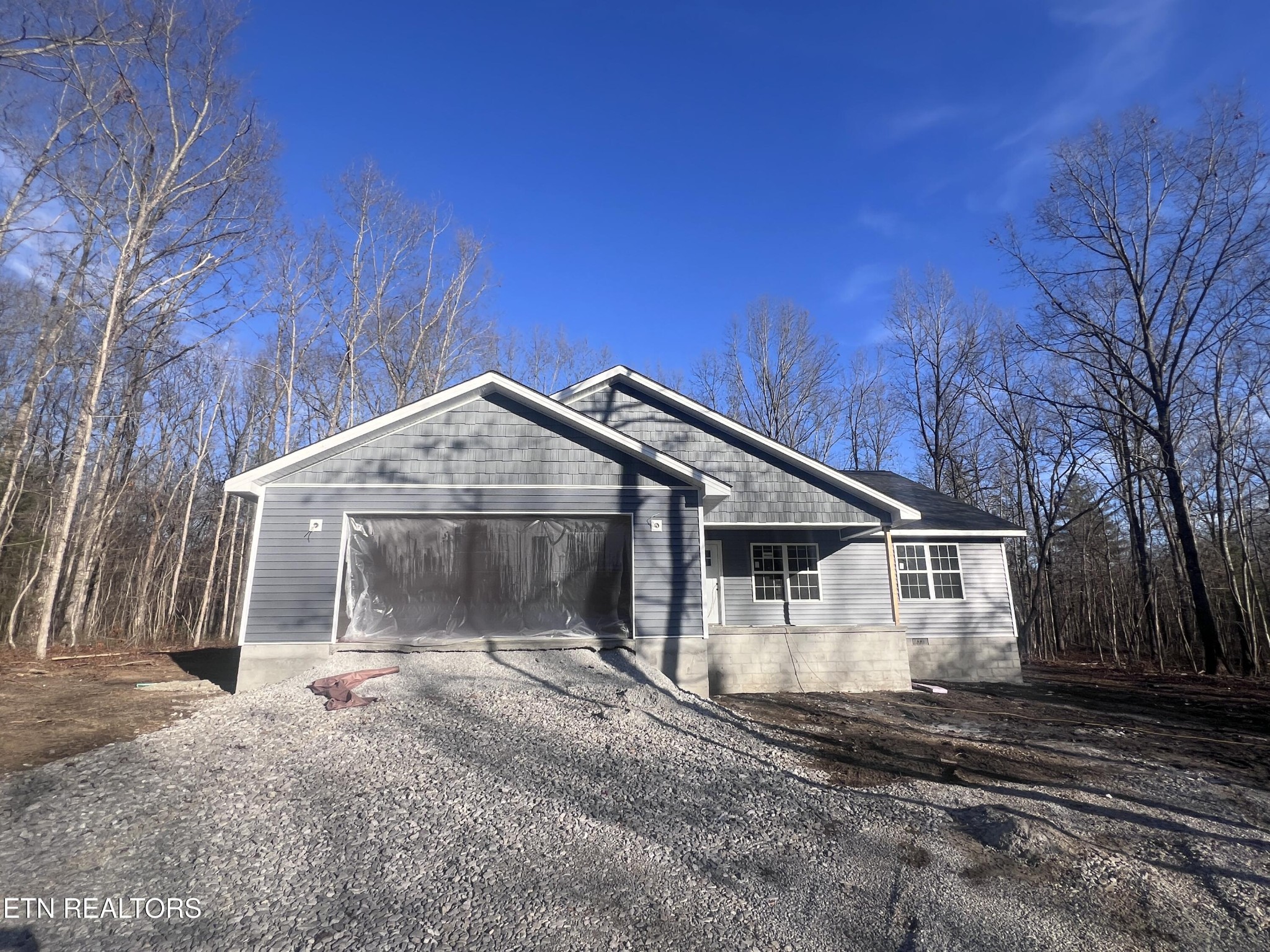 a view of a house with a yard and large tree