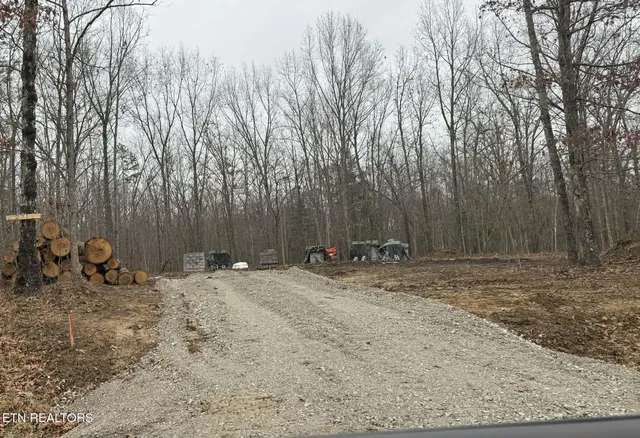 a backyard of a house with lawn chairs and wooden fence