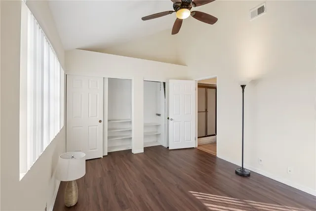 a view of a livingroom with wooden floor and a fireplace