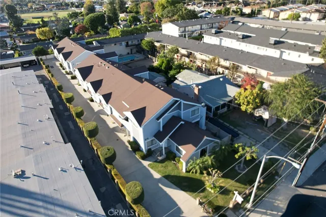 an aerial view of residential houses with outdoor space