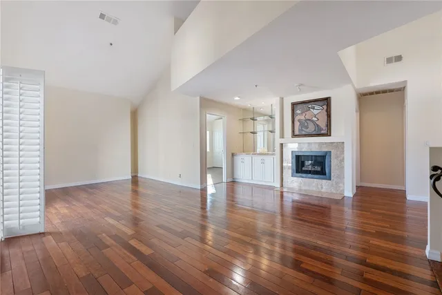 a living room with fireplace furniture and a wooden floor