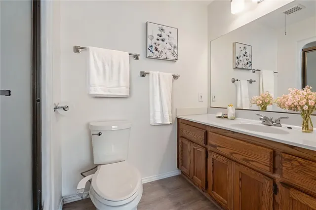 a bathroom with a toilet a sink and mirror