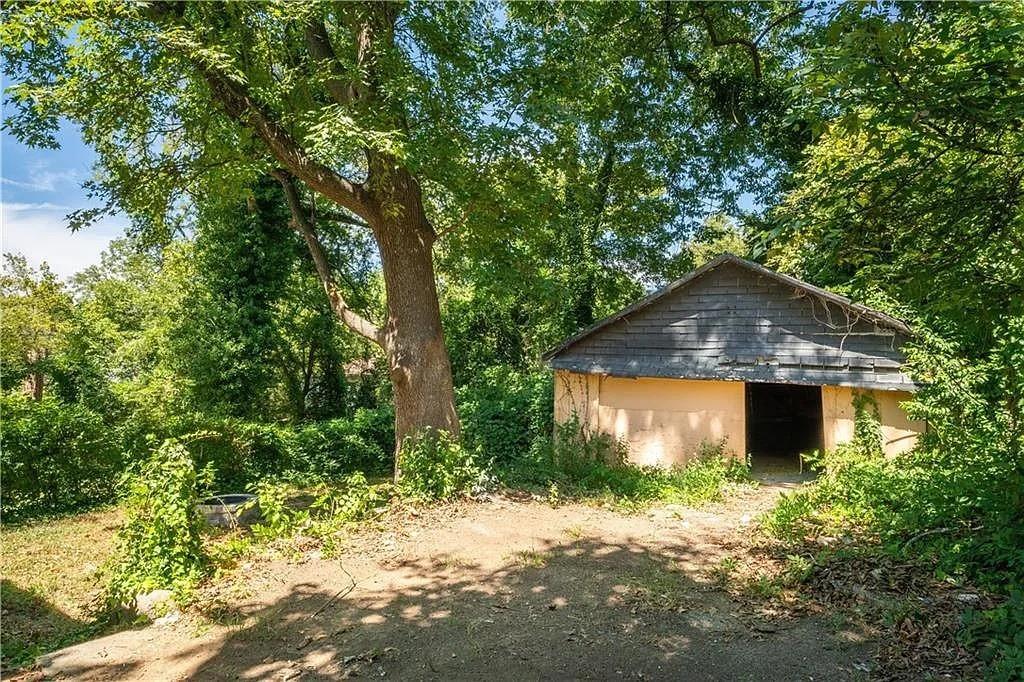 943 Rose Circle Southwest Atlanta, GA 30310 - Photo 23 of 33 a front view of a house with a yard and garage