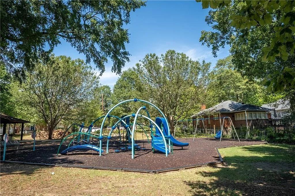 943 Rose Circle Southwest Atlanta, GA 30310 - Photo 25 of 33 a backyard of a house with large trees and table and chairs