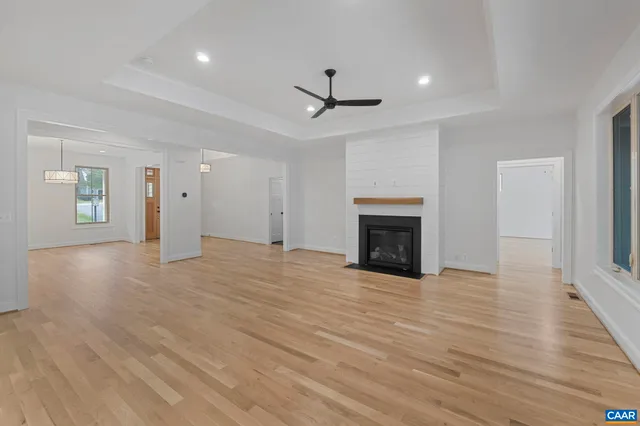 a view of a room with wooden floor and iron stairs