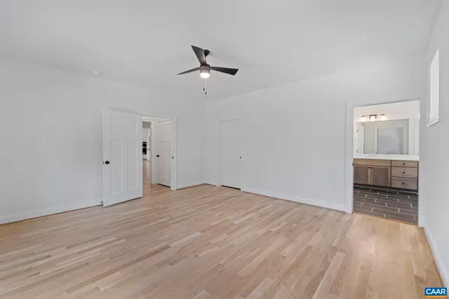 a view of an empty room with wooden floor
