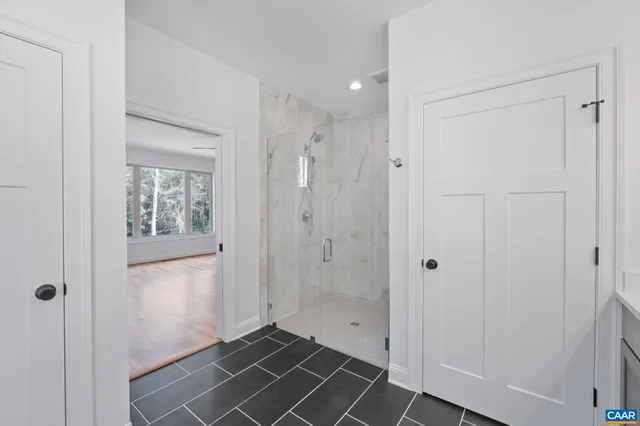a bathroom with a granite countertop sink a toilet and shower