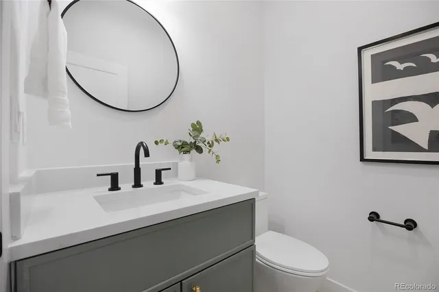 a bathroom with a sink a mirror and a toilet