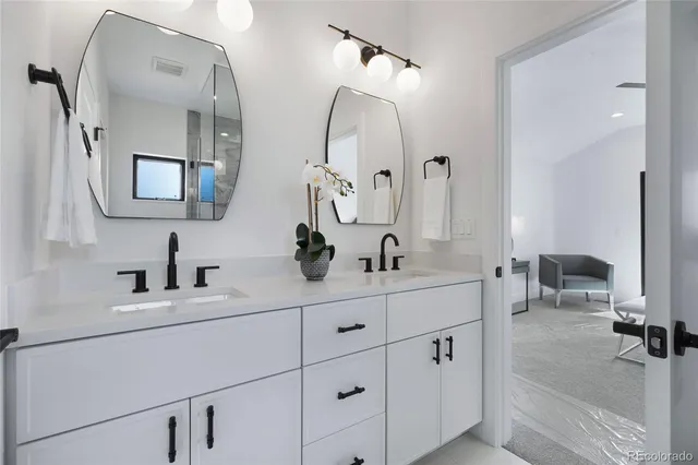 a bathroom with a double vanity sink mirror and