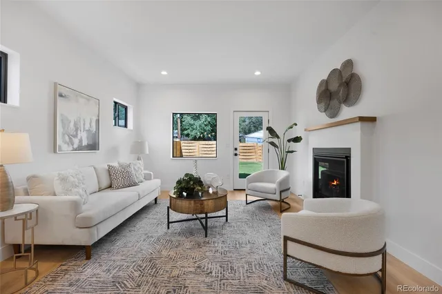a living room with furniture a window and a fireplace