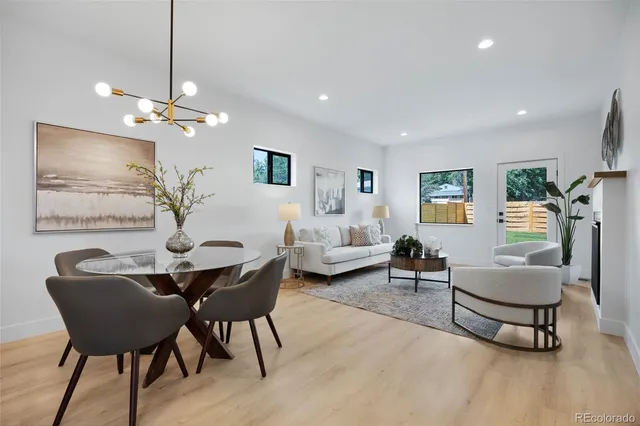 a living room with furniture a chandelier and a table