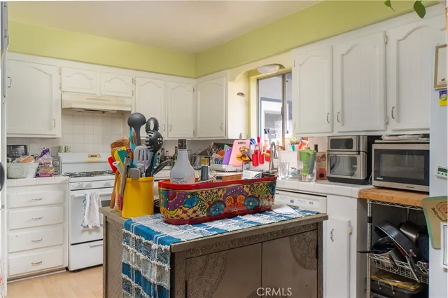 a bathroom with a sink and mirror with shower curtain