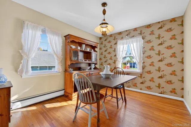 a view of a dining room with furniture window and wooden floor