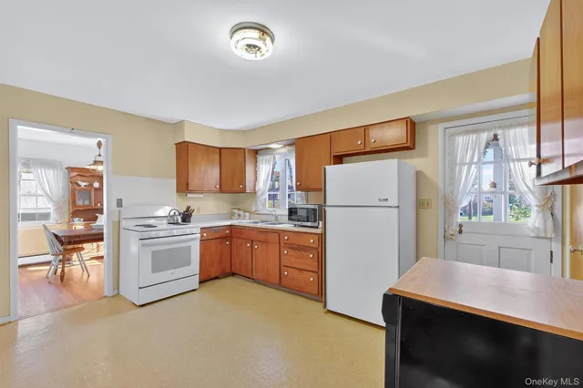 a kitchen with a refrigerator stove and sink